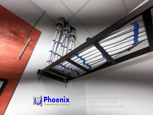 Network cabling infrastructure with CAT6 cabling and cable management system in Phoenix Defense facility.