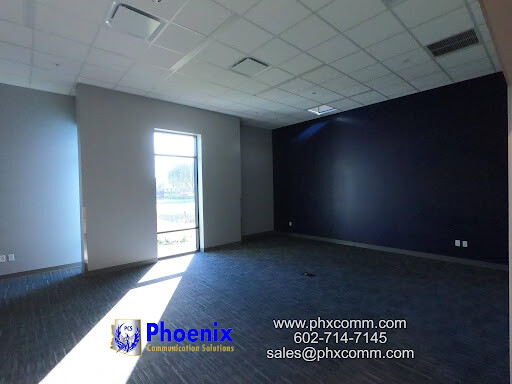 Phoenix Defense office space with new network cabling infrastructure and Phoenix Communication Solutions logo.