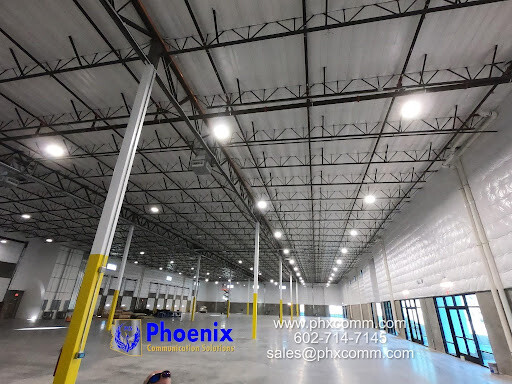 Phoenix Defense warehouse facility with network cabling infrastructure and lighting.