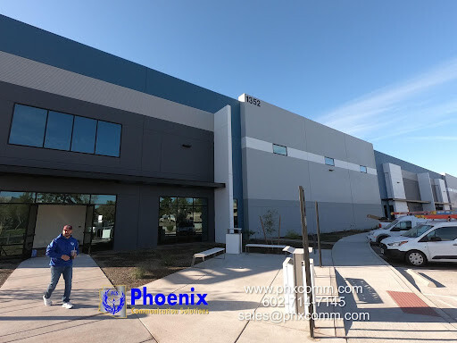 Phoenix Defense facility with Phoenix Communication Solutions branding and network cabling infrastructure.