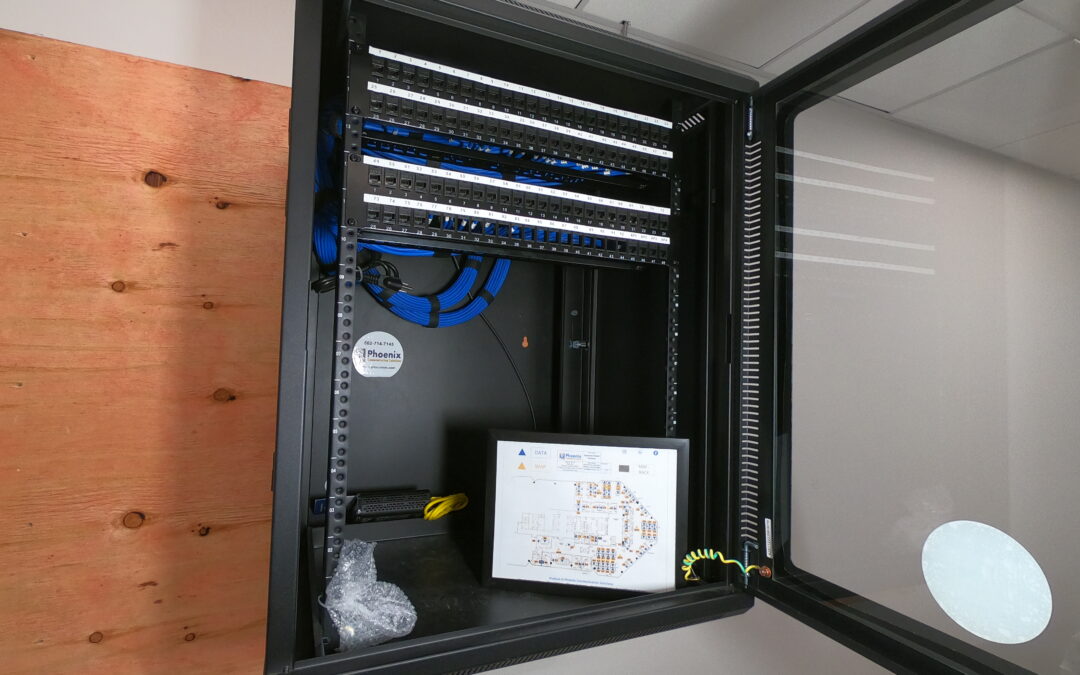 MDF buildout with Category 6 cable runs and network equipment by Phoenix Communication Solutions.