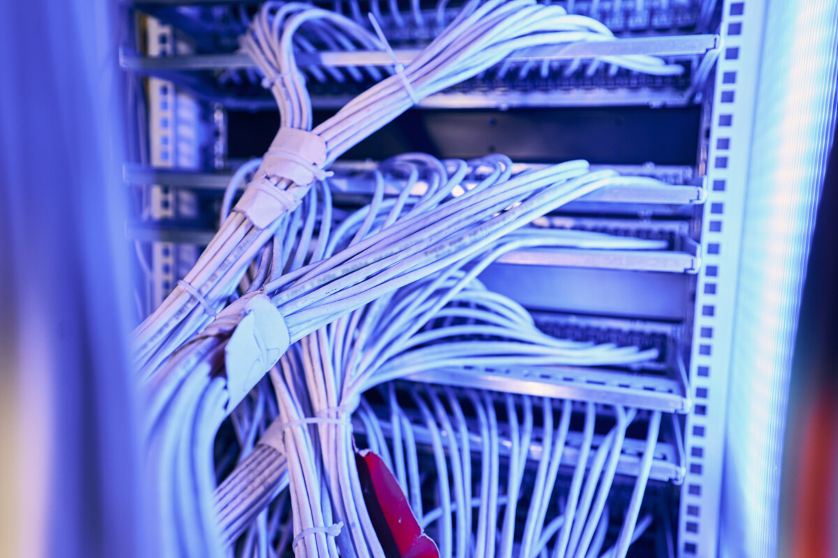 Organized network server cabling and low-voltage infrastructure in a network room.